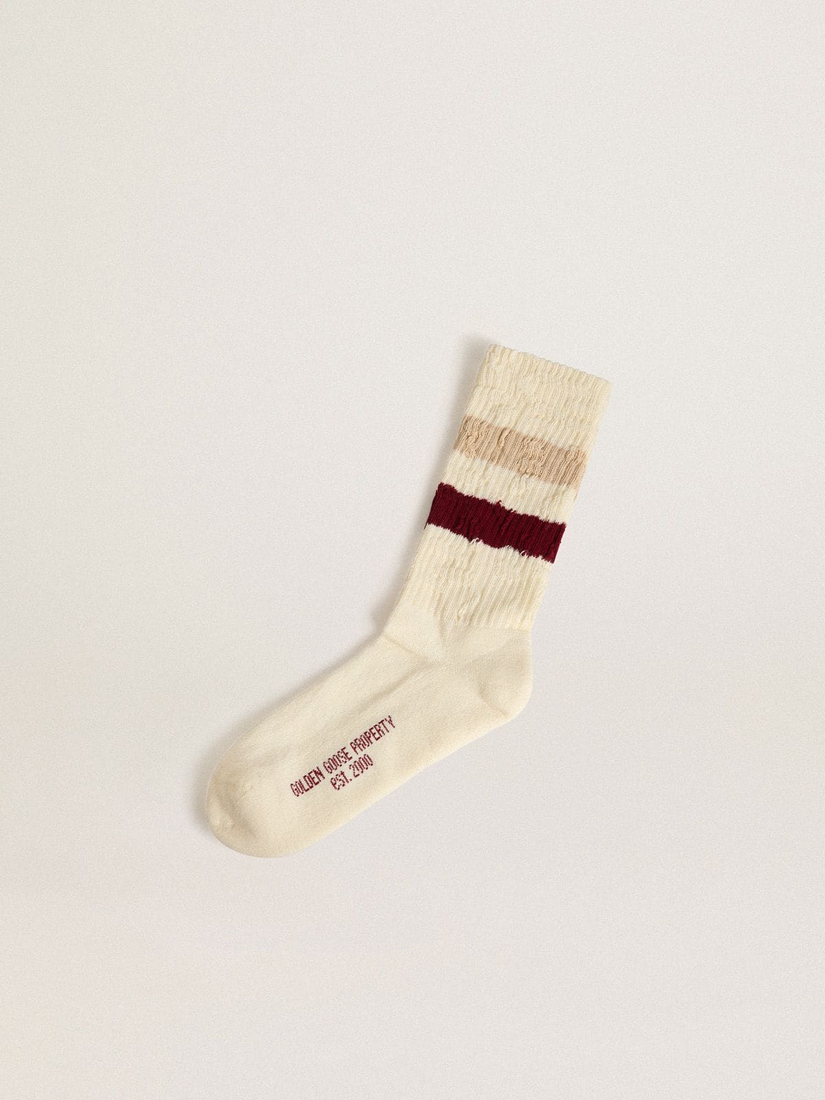 0a4c6dc3c2d44f38c2bf728e35f104acb9a5044b4e023dcd667d788db1179cc6 Worn-white socks with distressed details and beige and burgundy stripes - Image 1