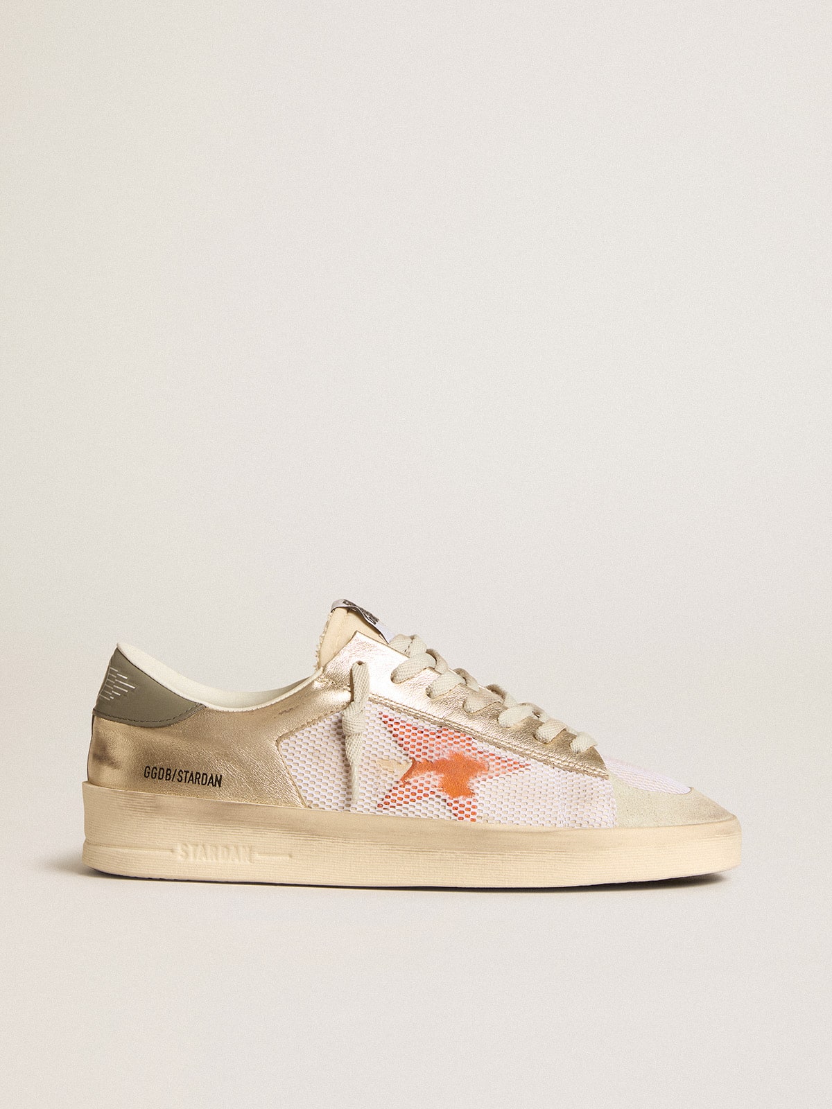 126029aca2aa423ac3768f9eae7c32e34cc577e82553884bfb33ccc2a063d949 Stardan in white mesh with orange star and platinum leather inserts - Image 1