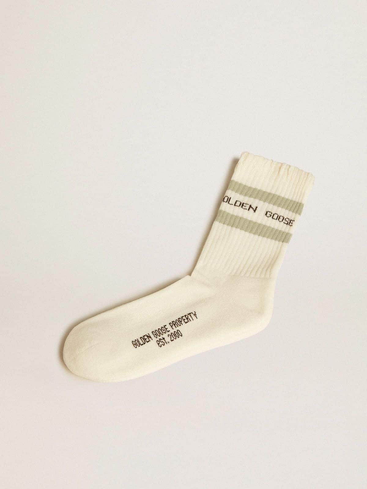 1a5a2088583e240ec4efb624dbd909f416cba09ff554c7e6393499a3f466c4e2 Worn-white socks with distressed details and sage-green stripes - Image 1