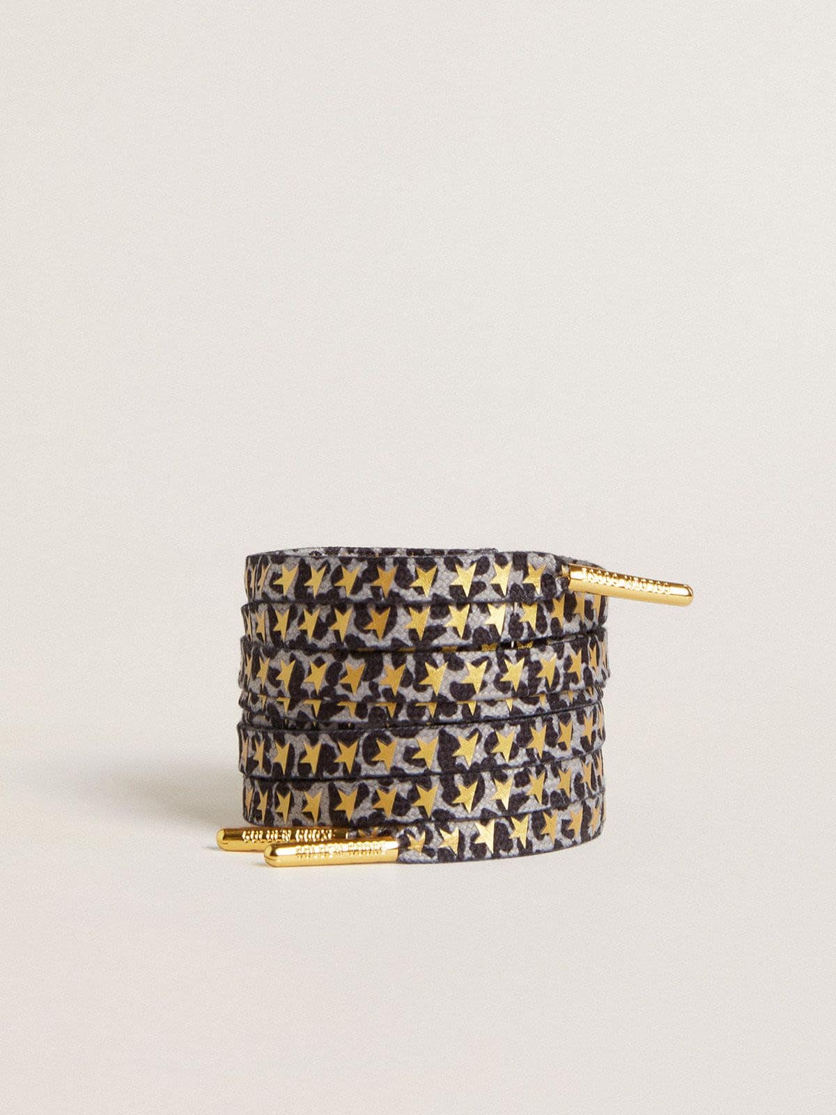 220d1c2956e26be14618b11078496c55a8247cf5473dd54d5a9e5d7a7034f4e4 Laces with gray and black animal print with contrasting gold stars - Image 1