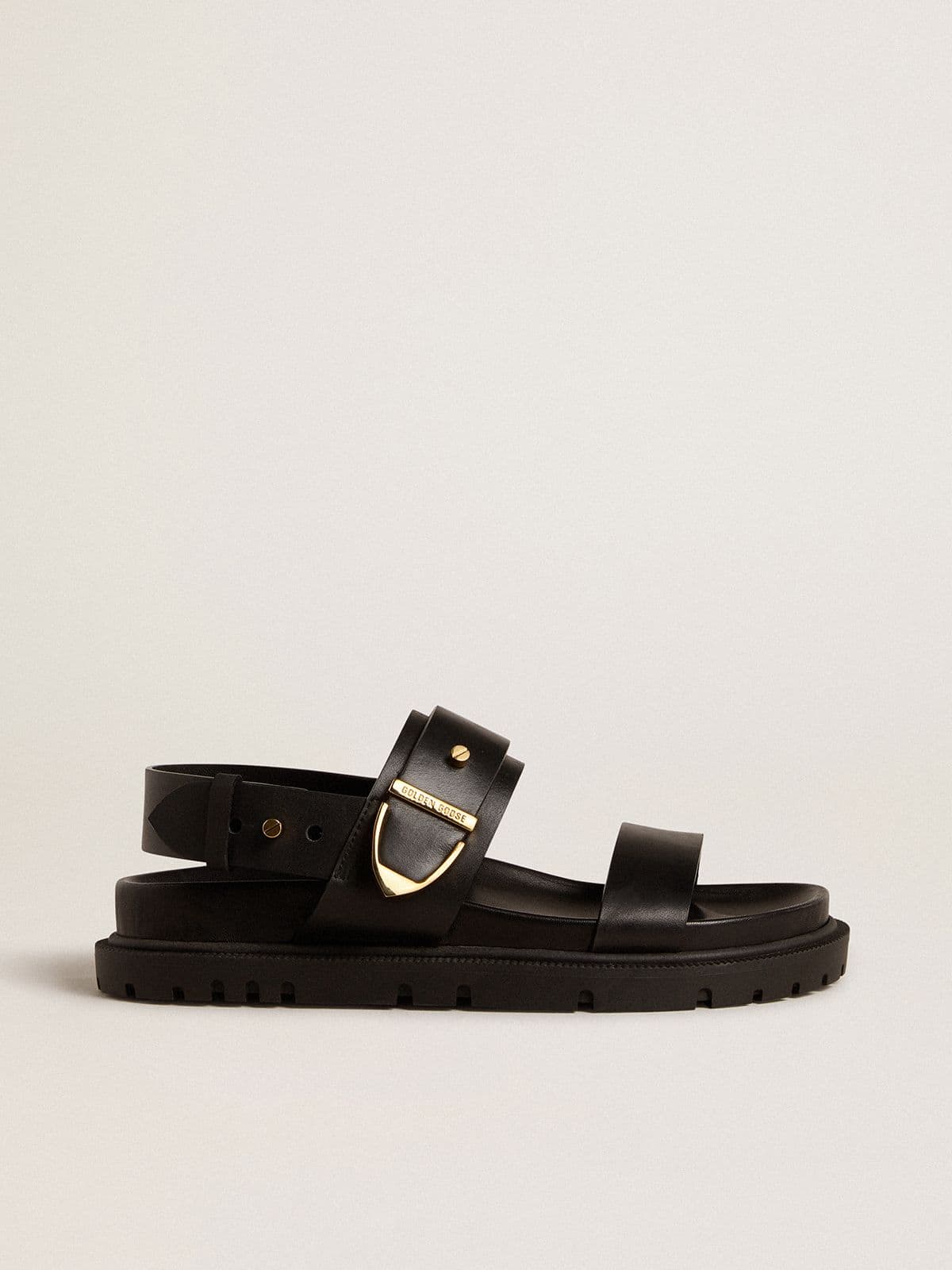26cf6cb10f621c22f1e3dfbb5d2ffce27332ea517670425324e54aa44cc9df01 Women's Lucy sandal in glossy black leather with gold metal buckle - Image 1