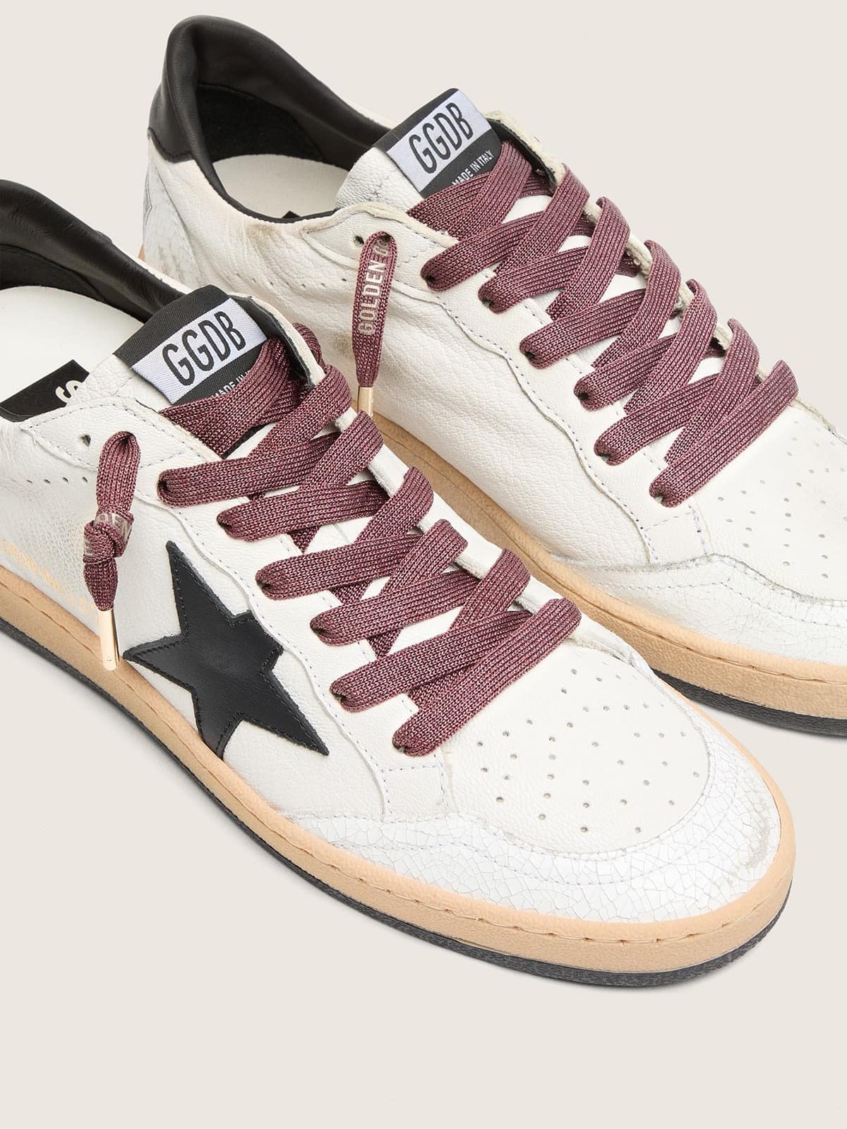 2cd62ae80b9e8afb1b26cb53cc53ae8ec9b734e35ab2339aff92586dfce3bd2b Burgundy laces with gold details - Image 1