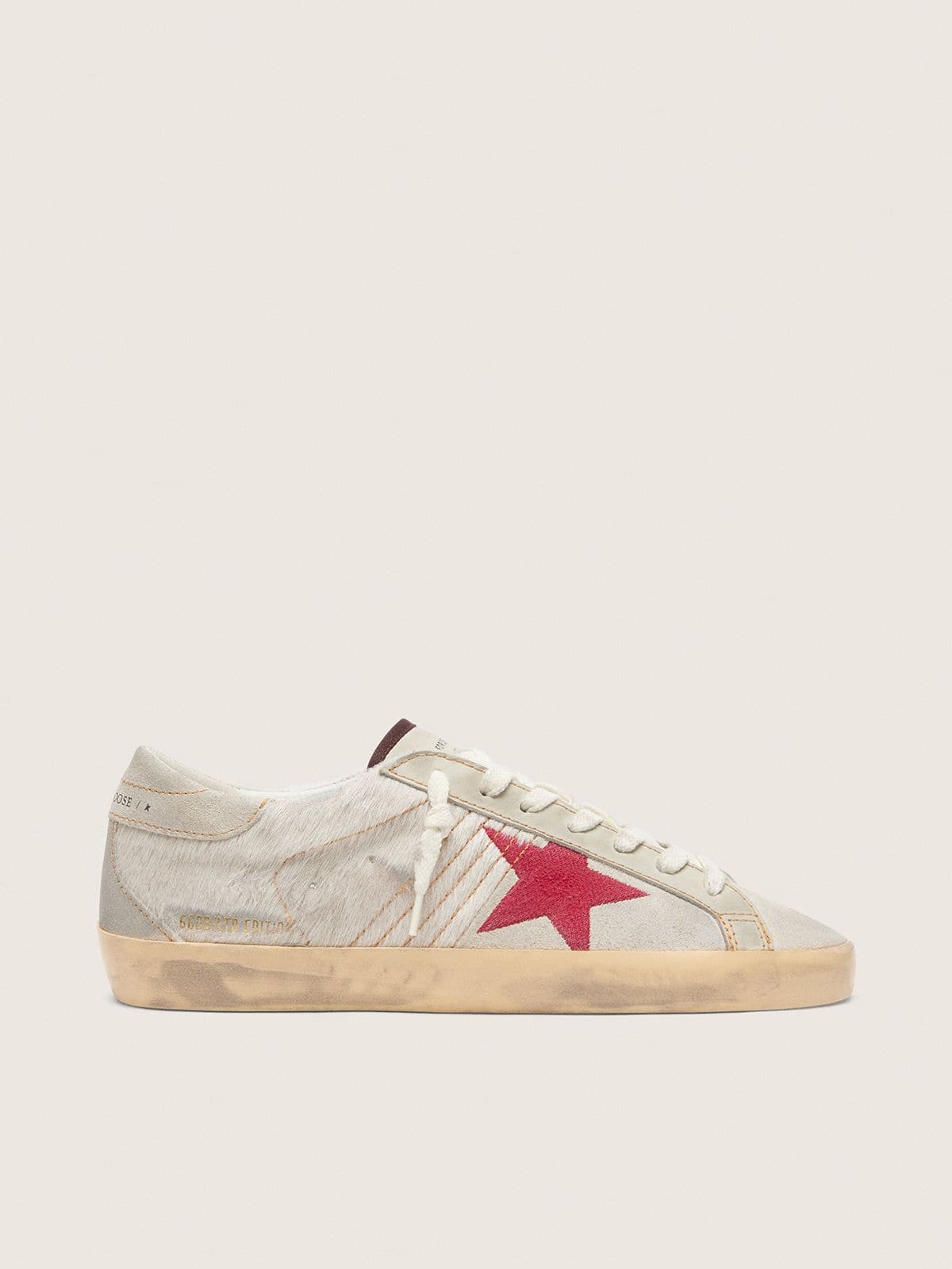 2f548ae9fade0f463ede199f27f200d869d6c98f07d05f5bf309a750fe886e16 Men's Super-Star LTD in white pony skin with red suede star - Image 1