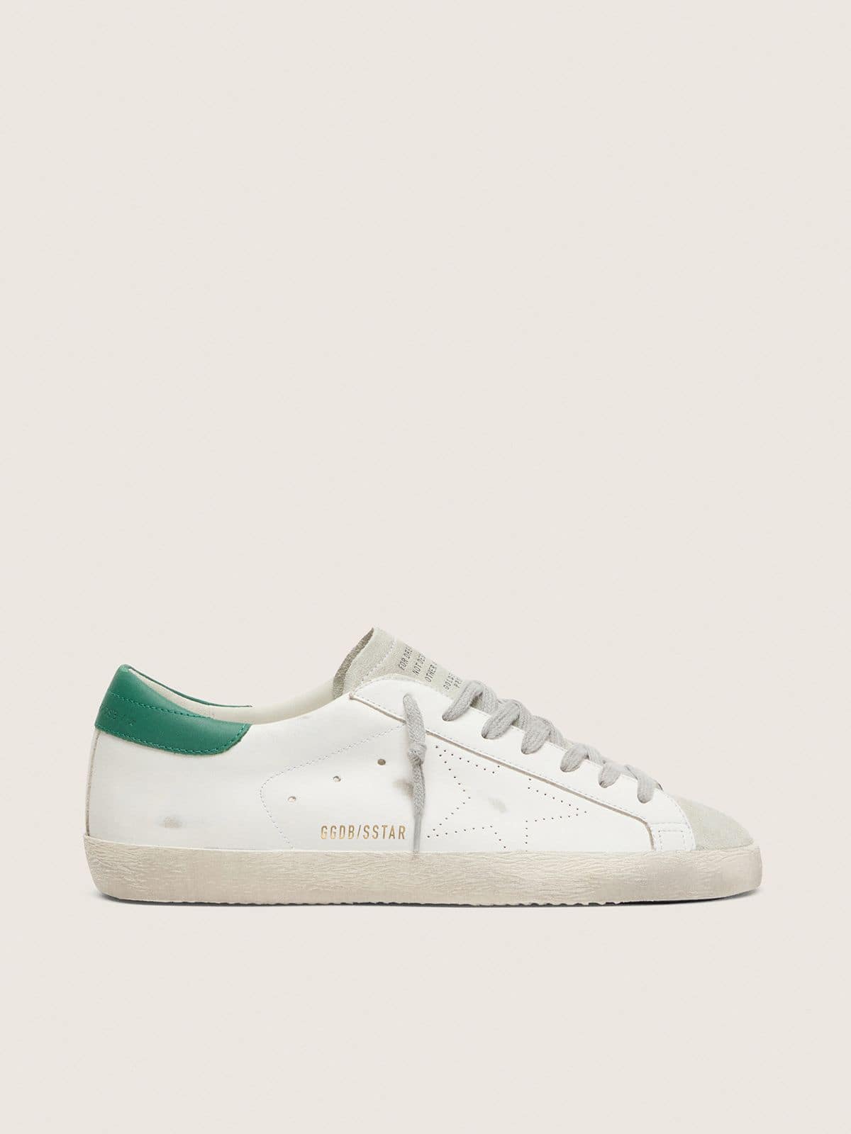 583955a7d80691e1fd4eab70f64c4f566e8ace7282205494462b4f6bb6c05f8d Men's Super-Star with perforated star and green heel tab - Image 1
