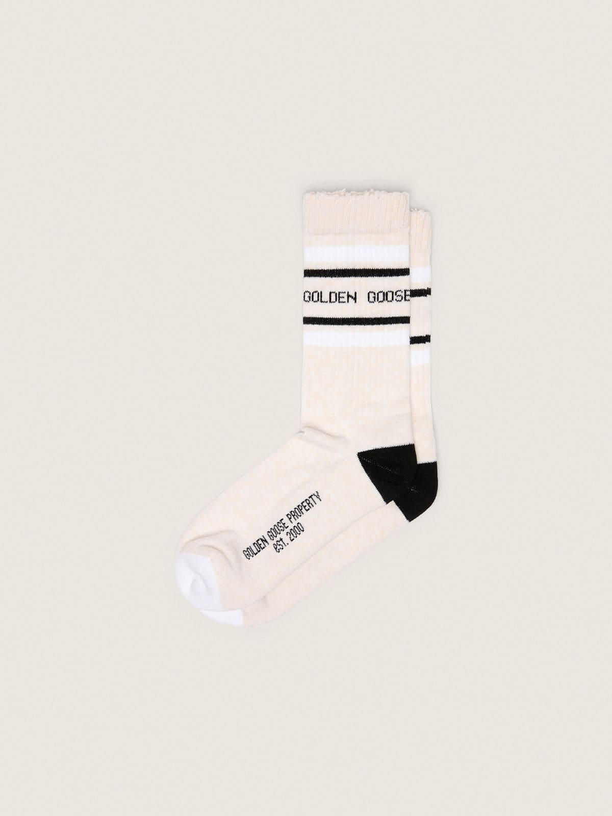 62a2ac8885e1a3a631e947bb28728c070f60760e2a8133d2f2dd2801b2775d3c Blush-colored socks with distressed details and black and white stripes - Image 1