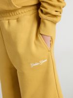Kids jogging shorts in ochre yellow with embroidery - Image 3