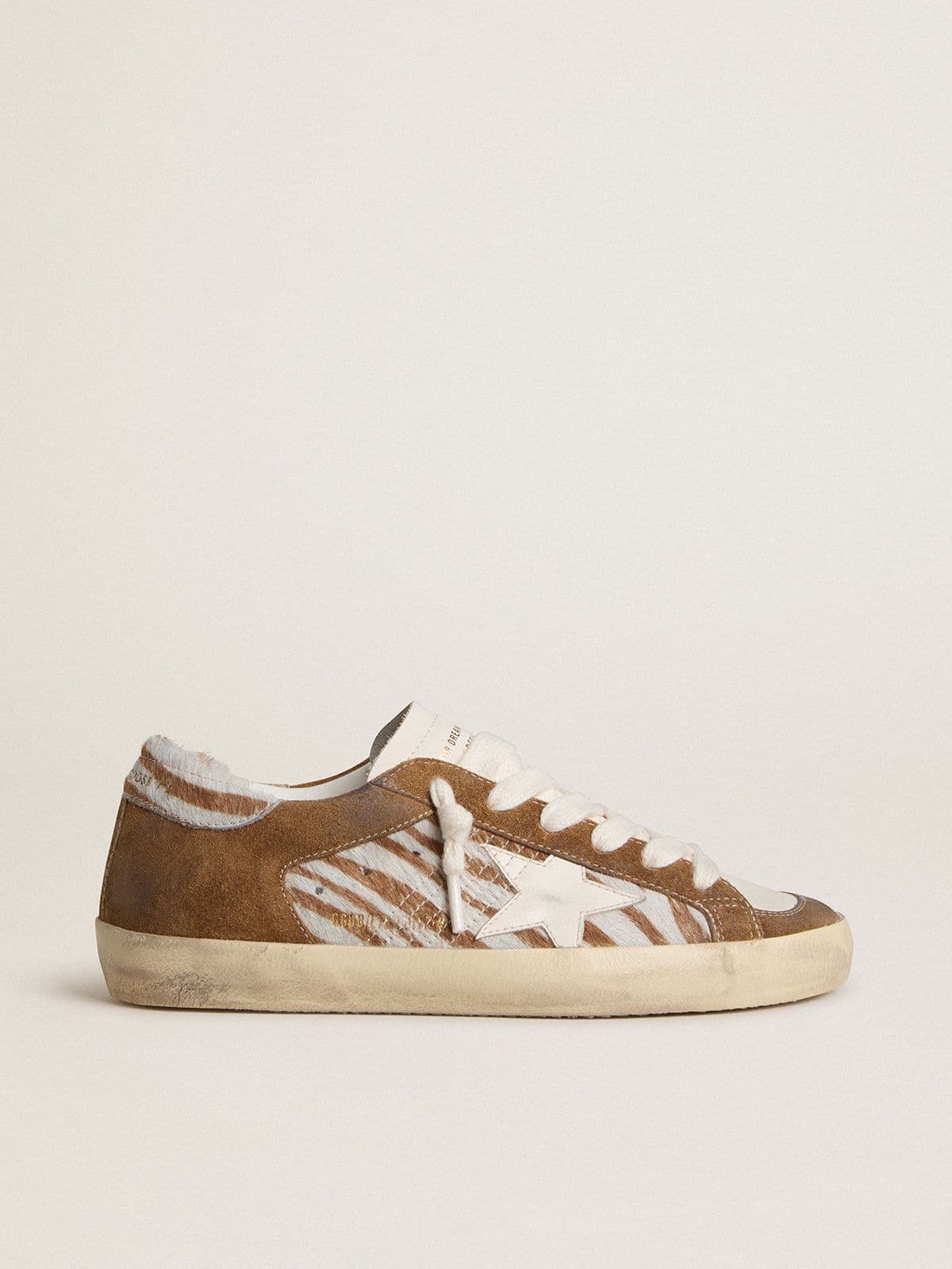 6ea6bbcde55639c00ba014e1548a083098294d1f81709891b953049a75d91c62 Women's Super-Star in zebra-print pony skin with leather star and brown suede inserts - Image 1