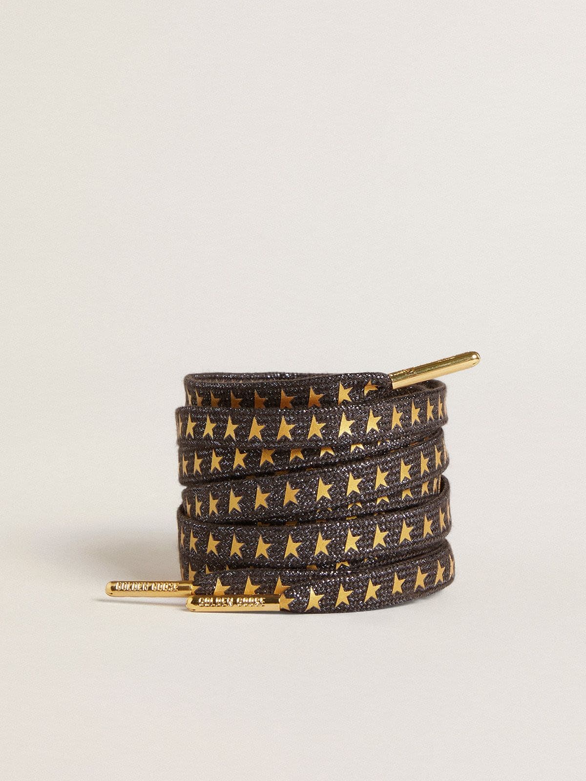 7db66b06d73ca4337221882b3d0e6255212ff977009793a15f424902e487cfb7 Dark gray Lurex laces with contrasting gold stars - Image 1