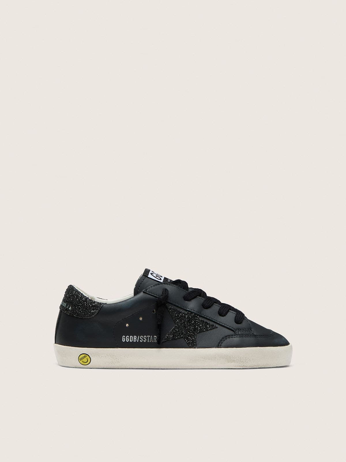 955d89a777af09fd569710577e6a0ad443bf648a0b15cfcb1a696c0fa9d7b7b7 Young Super-Star in black leather with black glitter star - Image 1