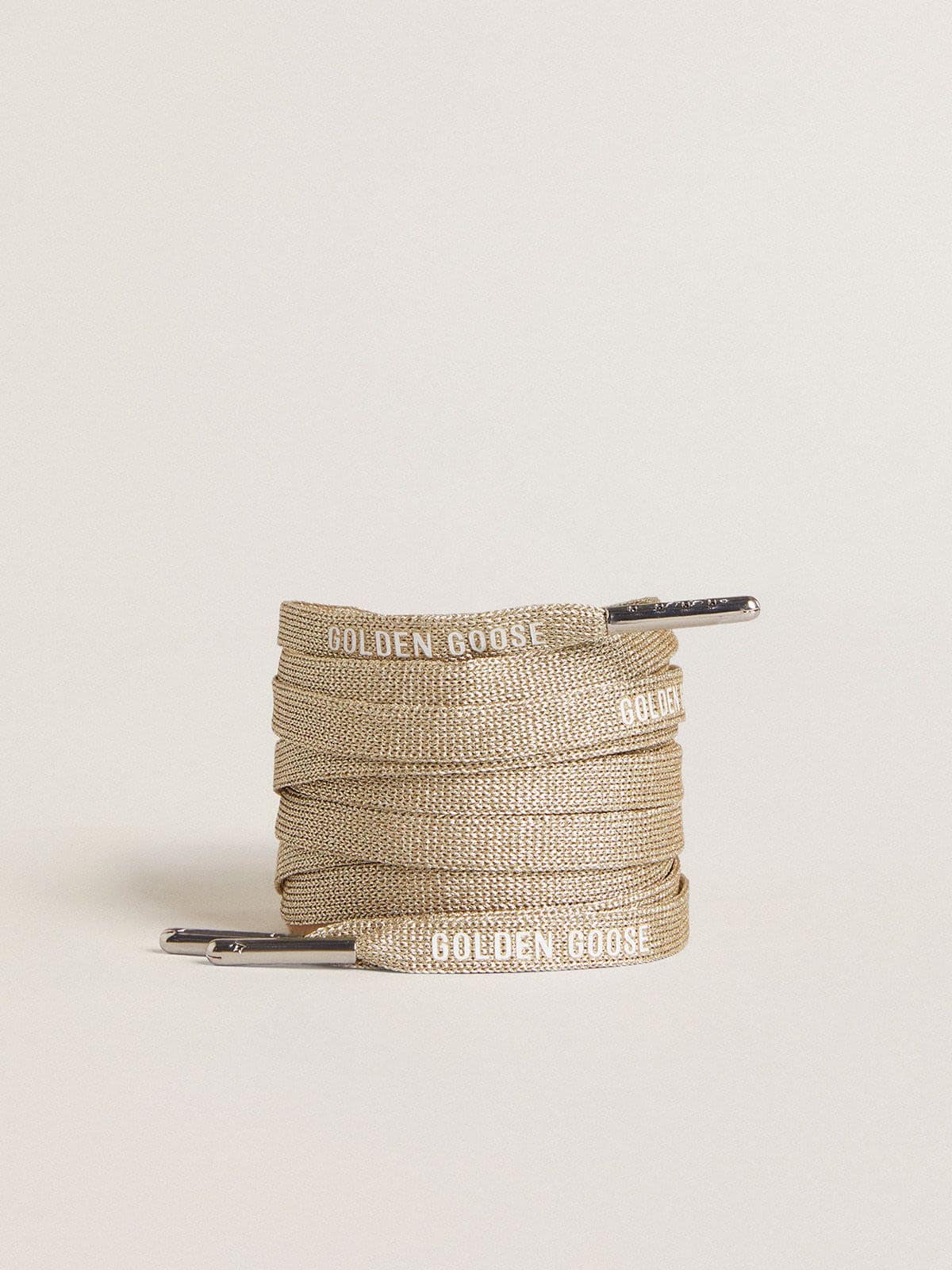 d8fb39c12a8fef45534d4b71b334b6f3ed00822d639801a65f2eeb599f8af7a1 Gold-colored Lurex laces with contrasting white logo - Image 1