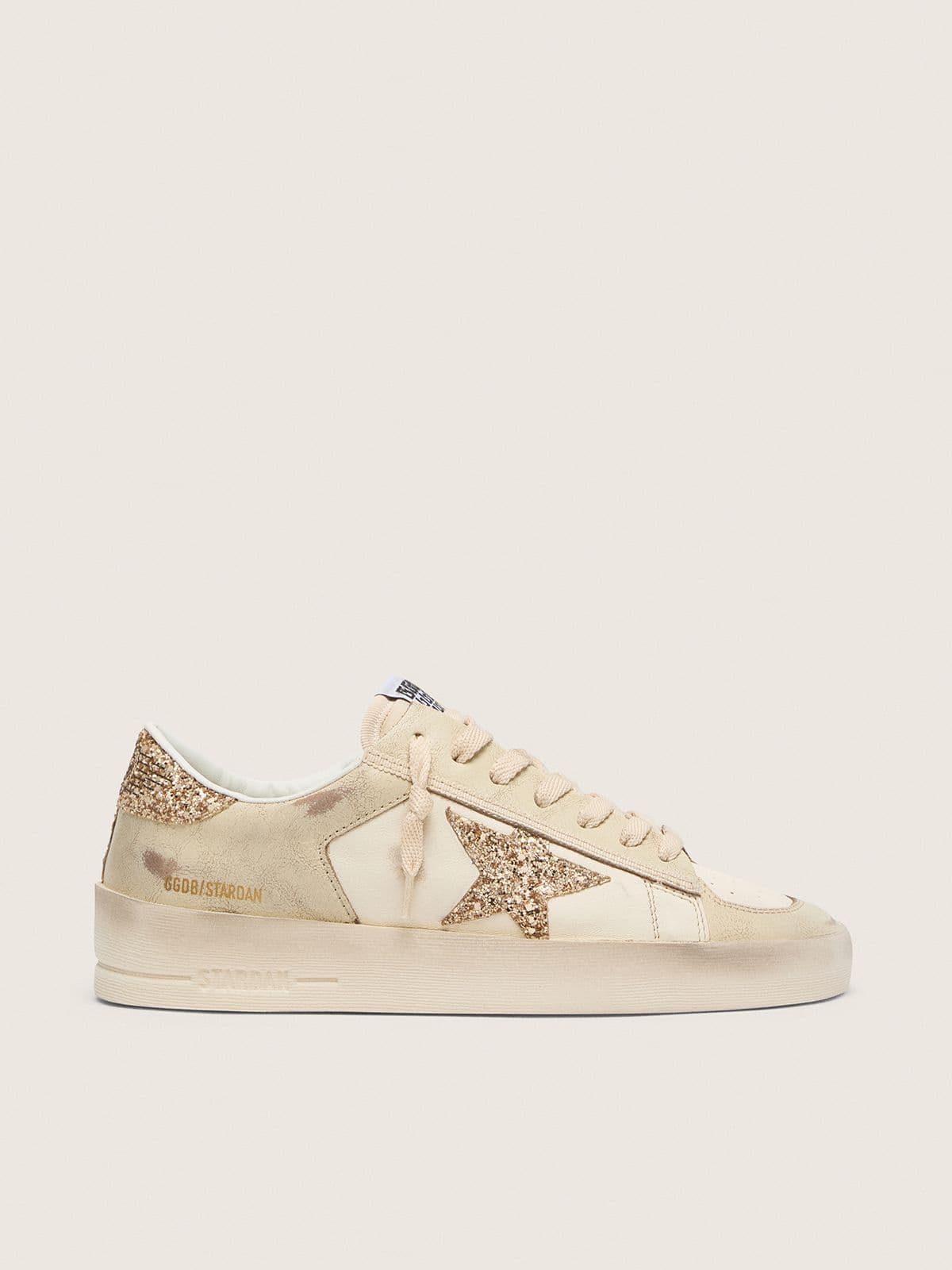 e0c80a0d0e33808364901ef09beaf461ef3083dd9ec4aa64d45e13f4fa460234 Women's Stardan in ecru nappa leather with gold glitter star and heel tab - Image 1